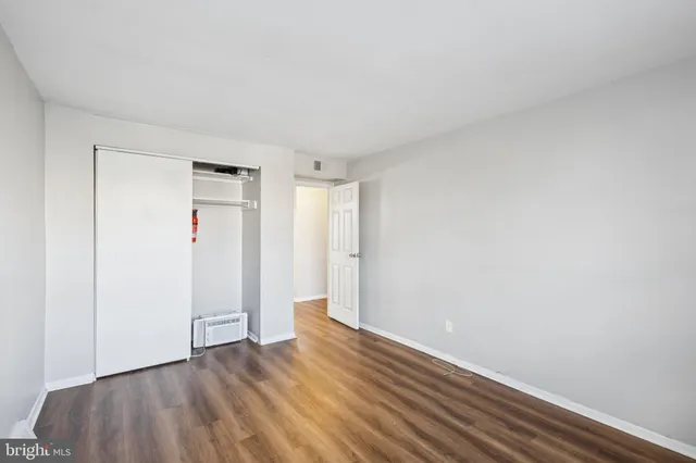 a view of an empty room and wooden floor
