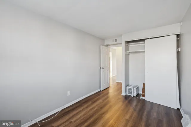 a view of an empty room and wooden floor