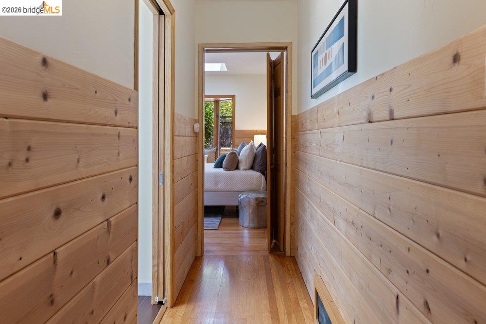 287 Purdue Avenue Kensington, CA 94708 - Photo 46 of 60 Hallway featuring wood-finish paneling, hardwood flooring, and a recessed air vent