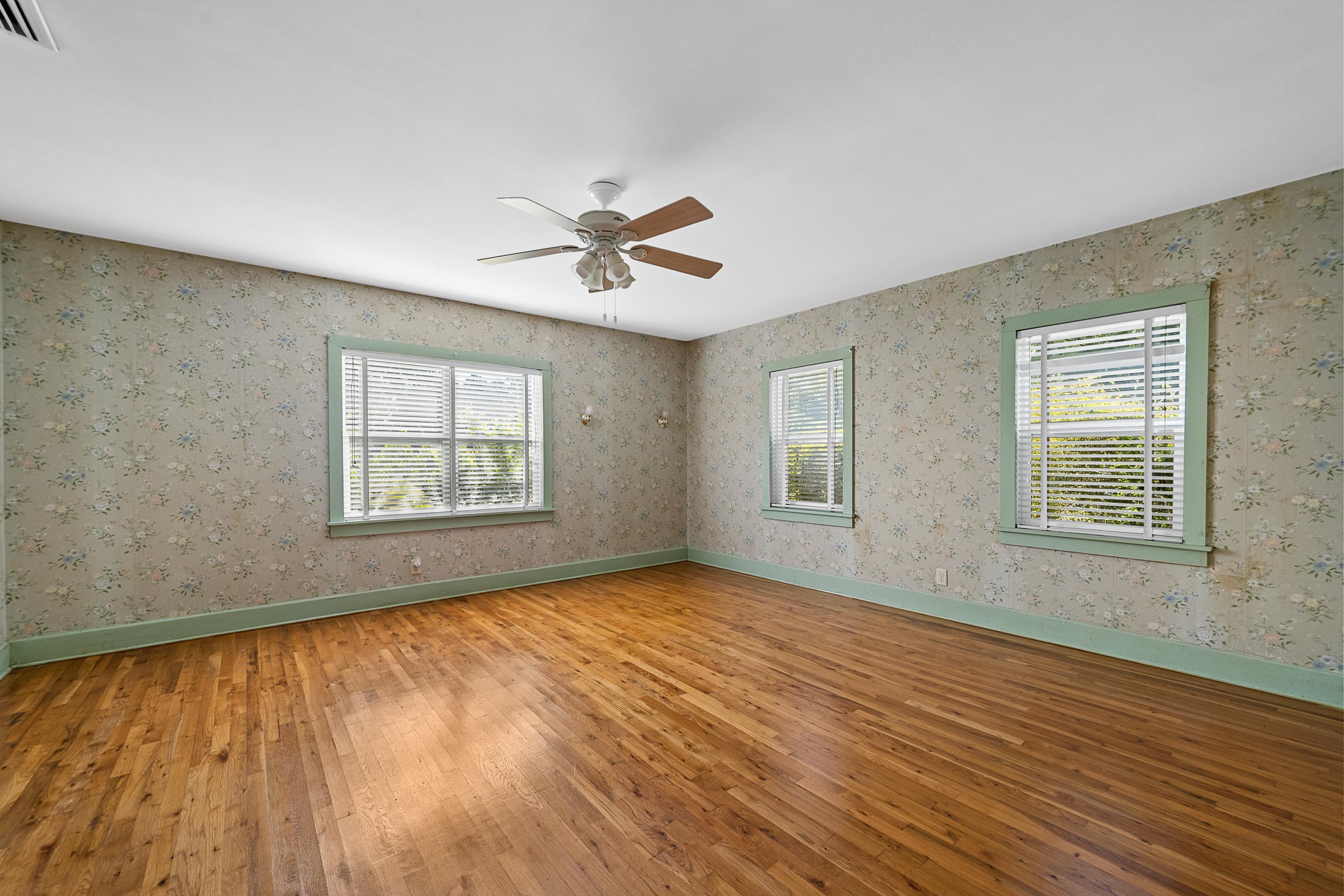 9350 Tompkins Road Stockton, AL 36579 - Photo 16 of 36 Empty room featuring wood-type flooring and a ceiling fan