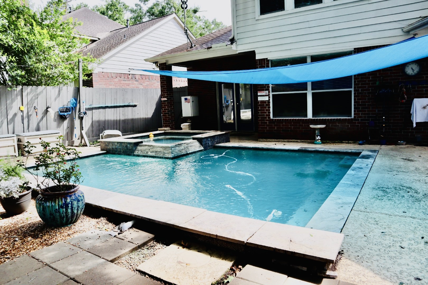 19114 Emory Trail Spring, TX 77388 - Photo 27 of 32 Welcome to your private oasis featuring your pool and attached spa! The area is surrounded by a wooden fence and features a shaded patio space. Add yourself a few potted plants for a tropical feel with minimal landscaping, creating a cozy outdoor retreat.