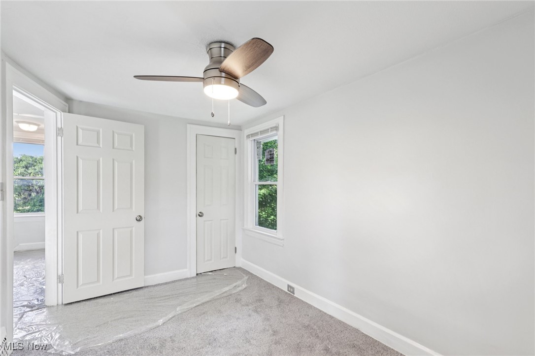 1469 South Noble Road Cleveland, OH 44121 - Photo 17 of 29 Unfurnished bedroom with carpet floors, multiple windows, and ceiling fan