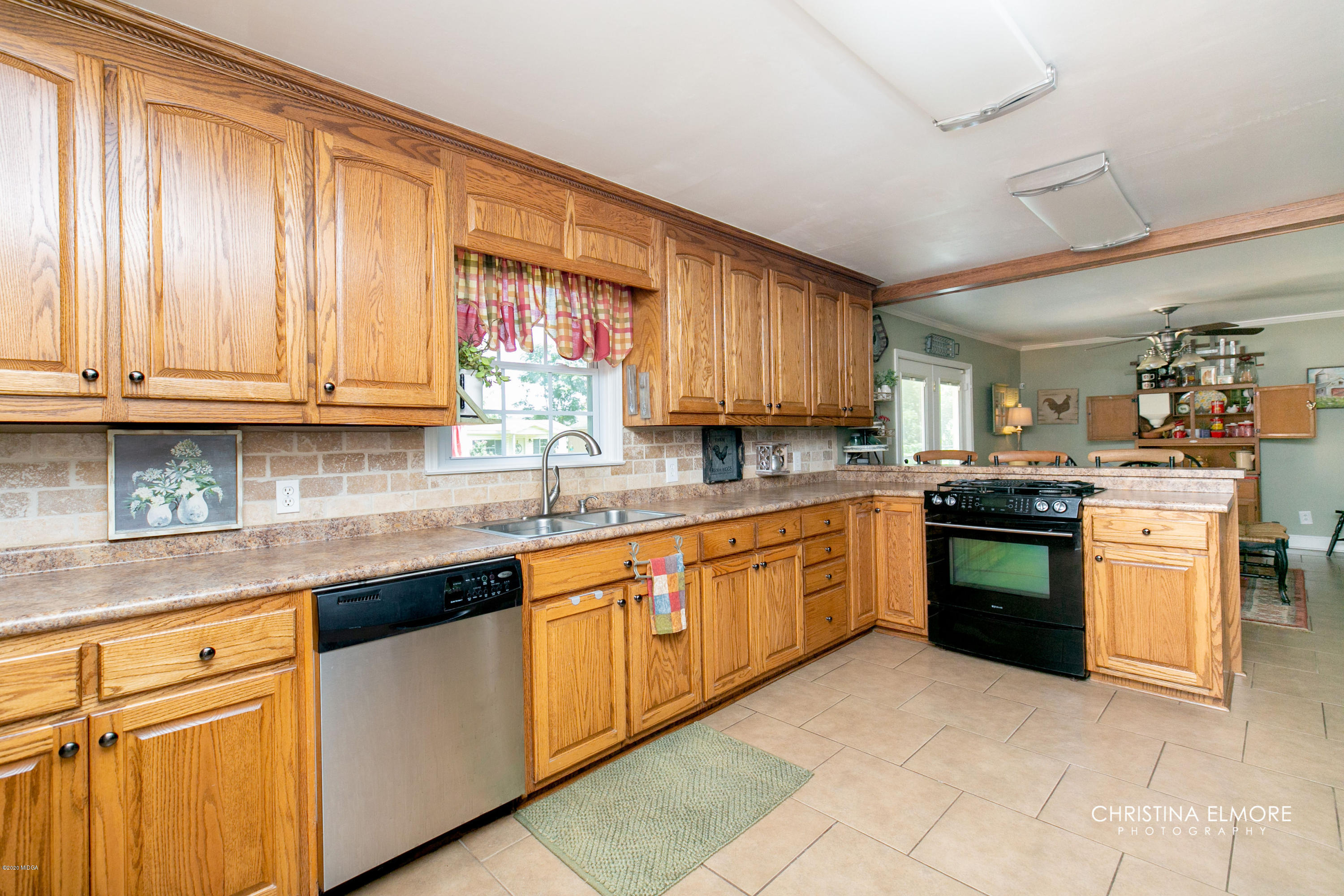3673 Jones Road Macon, GA 31216 - Photo 11 of 34 a kitchen with stainless steel appliances granite countertop a stove sink and cabinets