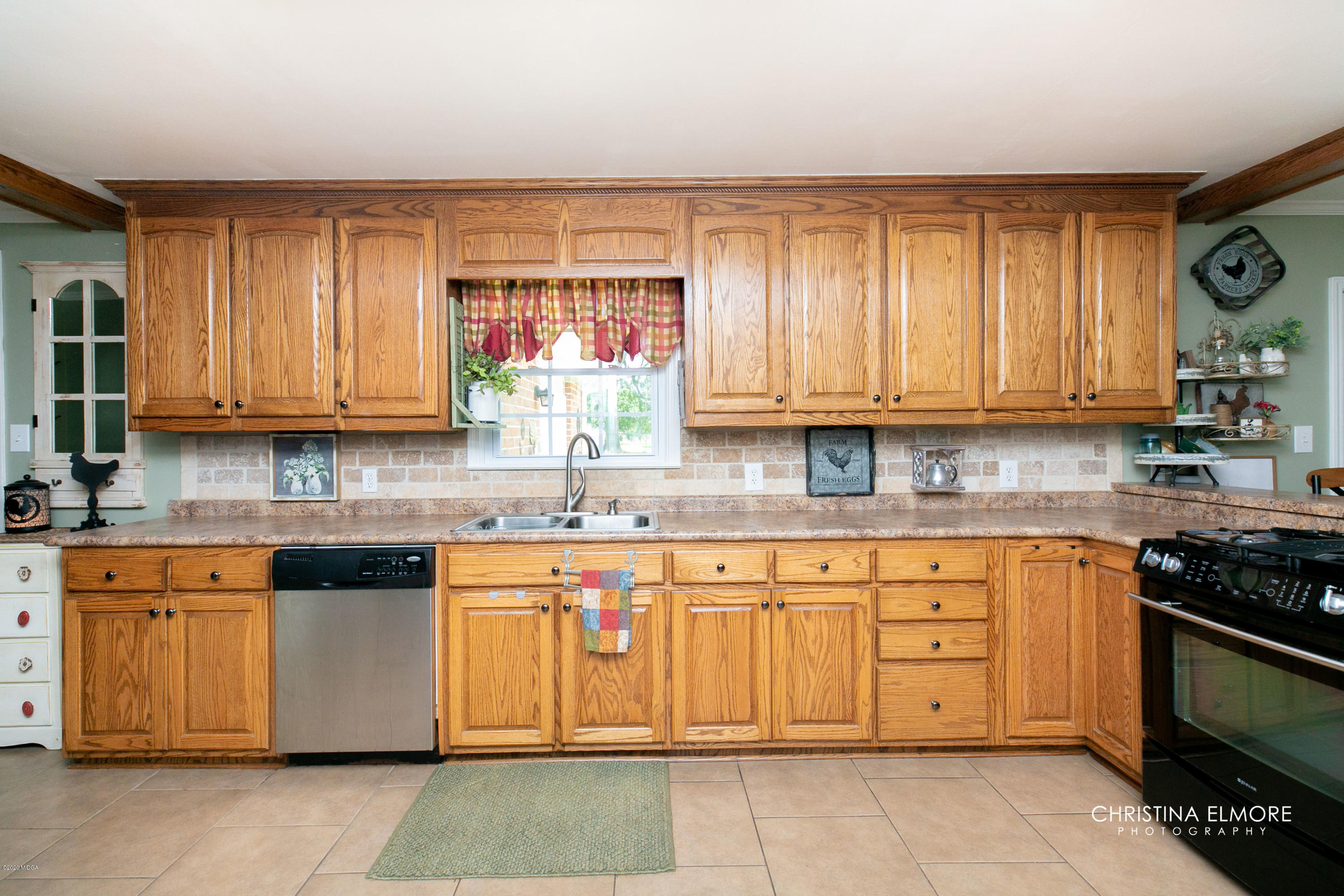 3673 Jones Road Macon, GA 31216 - Photo 12 of 34 a kitchen with stainless steel appliances granite countertop a stove a sink and a microwave