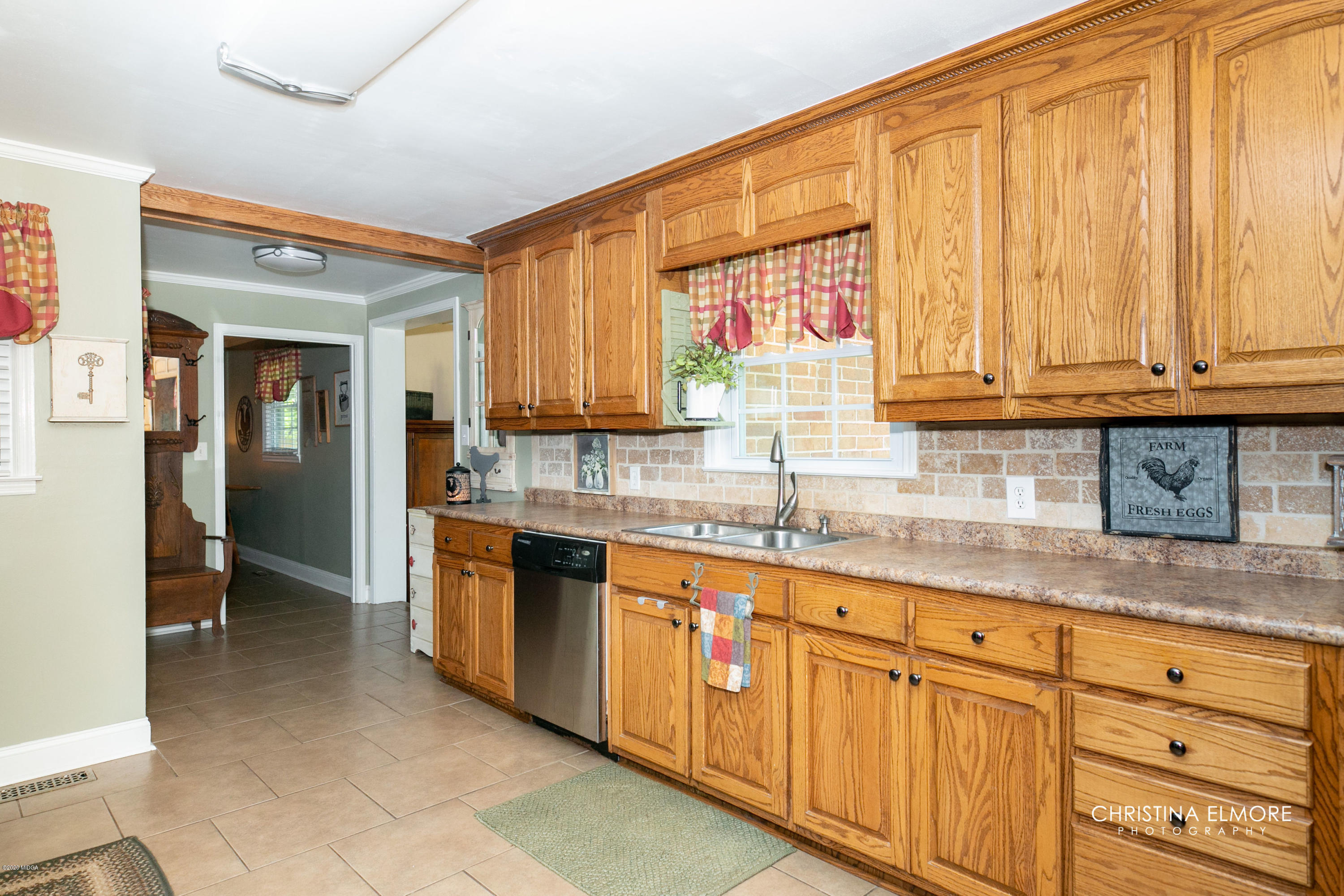 3673 Jones Road Macon, GA 31216 - Photo 13 of 34 a kitchen with granite countertop a sink window and cabinets