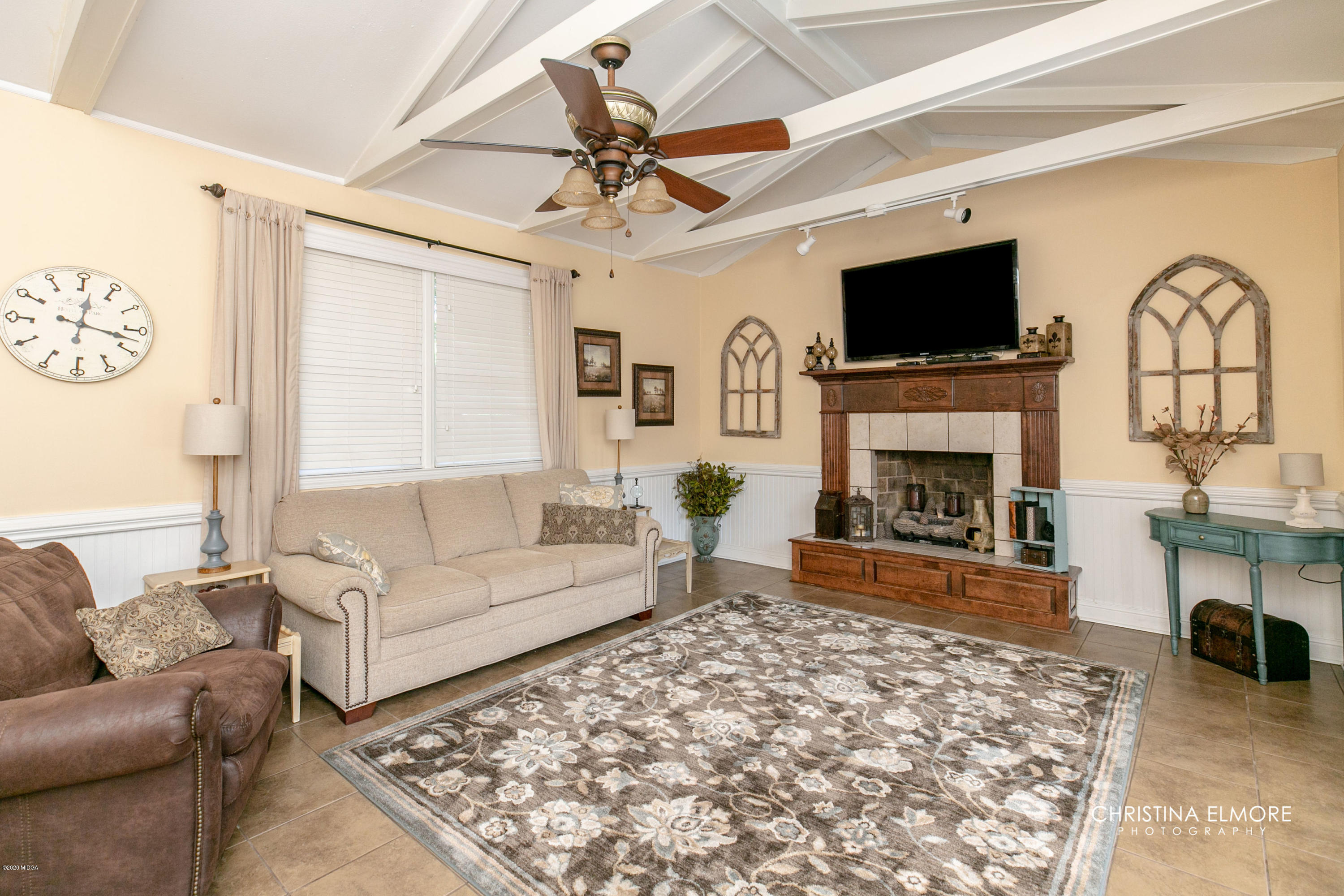 3673 Jones Road Macon, GA 31216 - Photo 3 of 34 a living room with furniture a flat screen tv and a fireplace