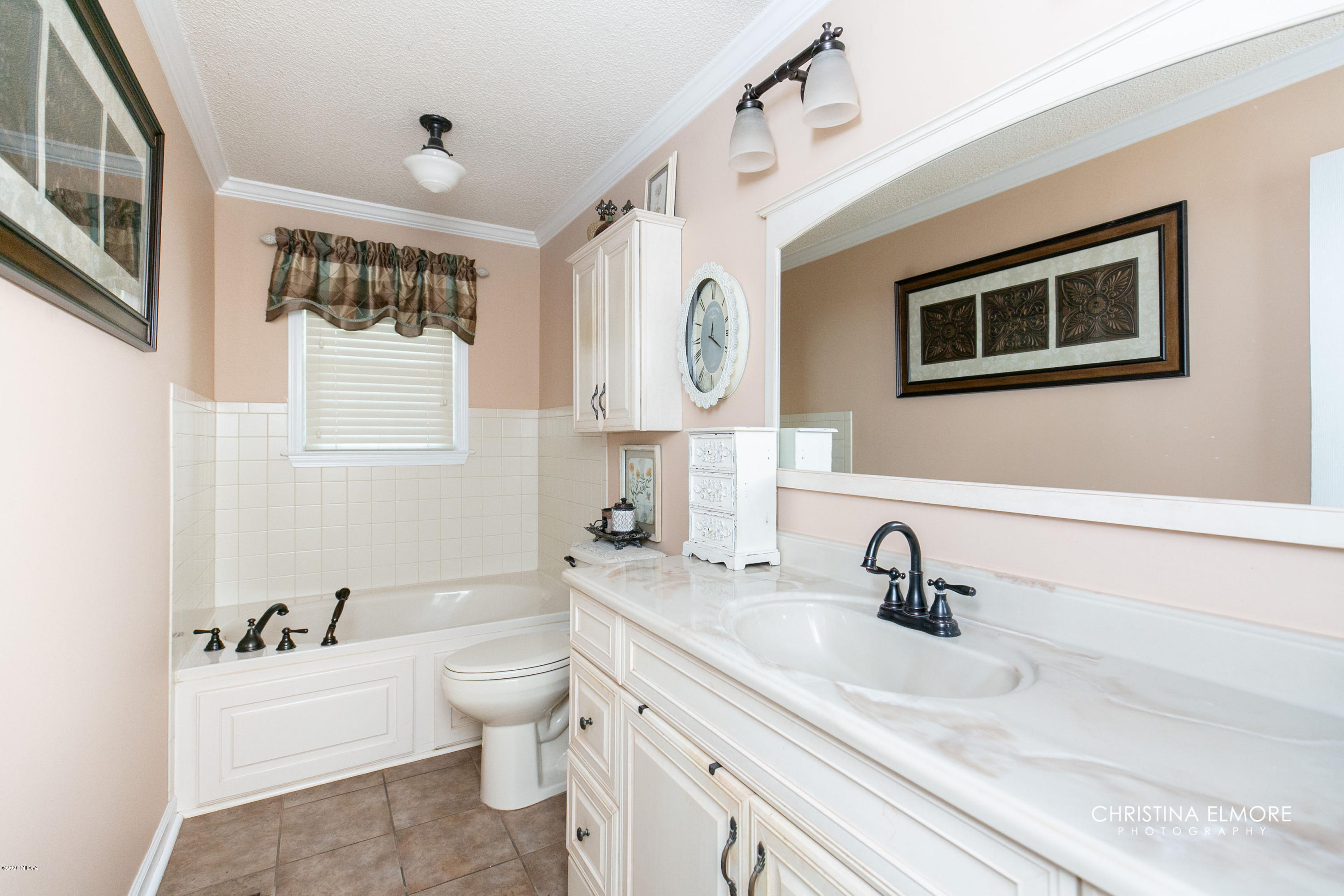 3673 Jones Road Macon, GA 31216 - Photo 26 of 34 a bathroom with a toilet sink a mirror and vanity