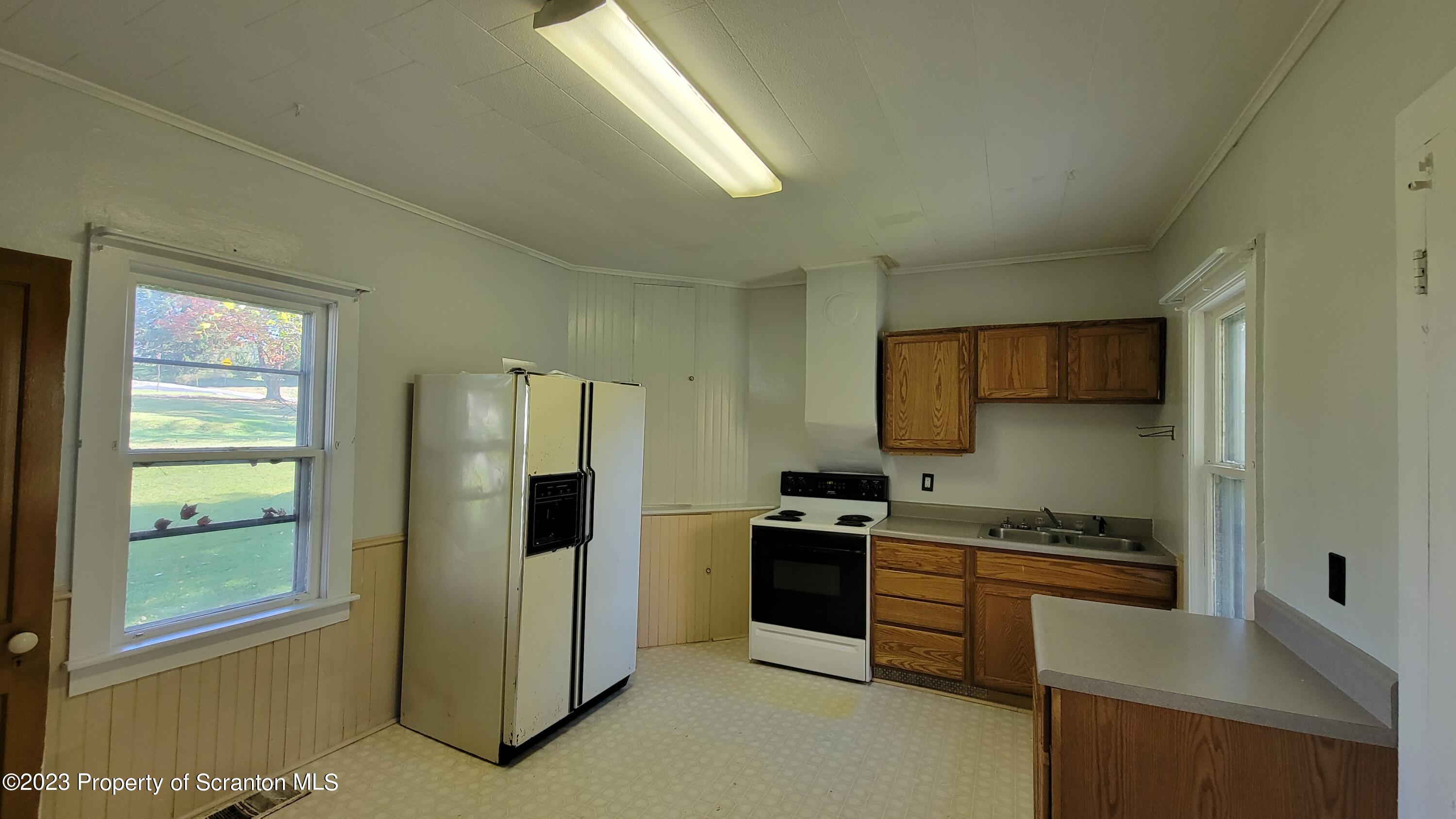 232 Vine Street Forest City, PA 18421 - Photo 12 of 24 a kitchen with stainless steel appliances a stove and a refrigerator
