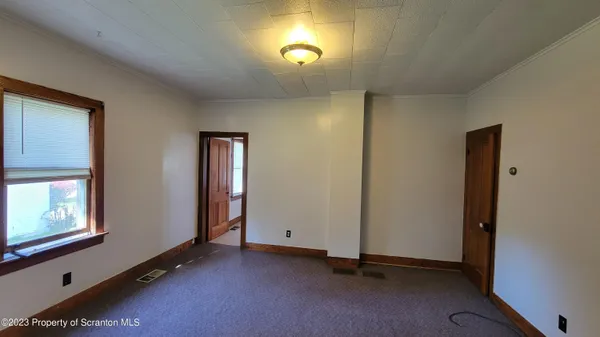 a view of an empty room and window