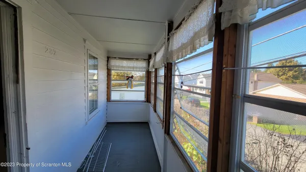 a view of a glass door with a yard from a window