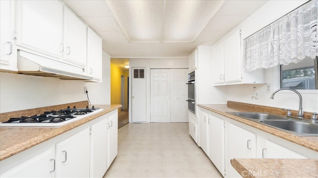416 Jeffries, Unit 5 Monrovia, CA 91016 - Photo 7 of 20 a kitchen with stainless steel appliances granite countertop a sink stove and cabinets