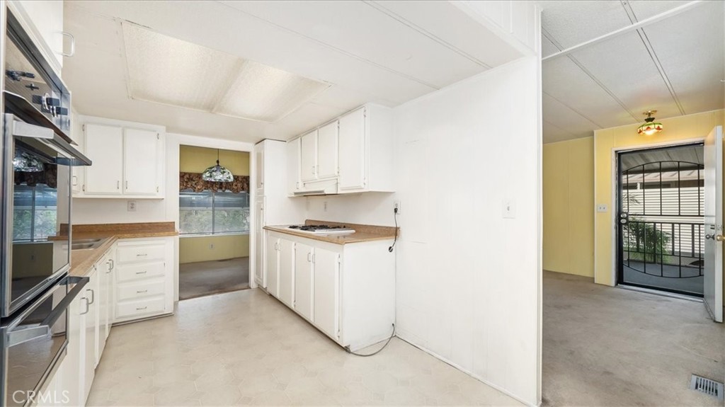 416 Jeffries, Unit 5 Monrovia, CA 91016 - Photo 9 of 20 a kitchen with stainless steel appliances kitchen island granite countertop a refrigerator and a sink