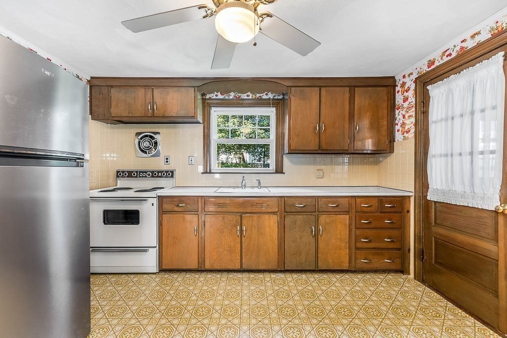 12 Juniper Terrace Dedham, MA 02026 - Photo 13 of 41 a kitchen with stainless steel appliances a refrigerator sink and cabinets