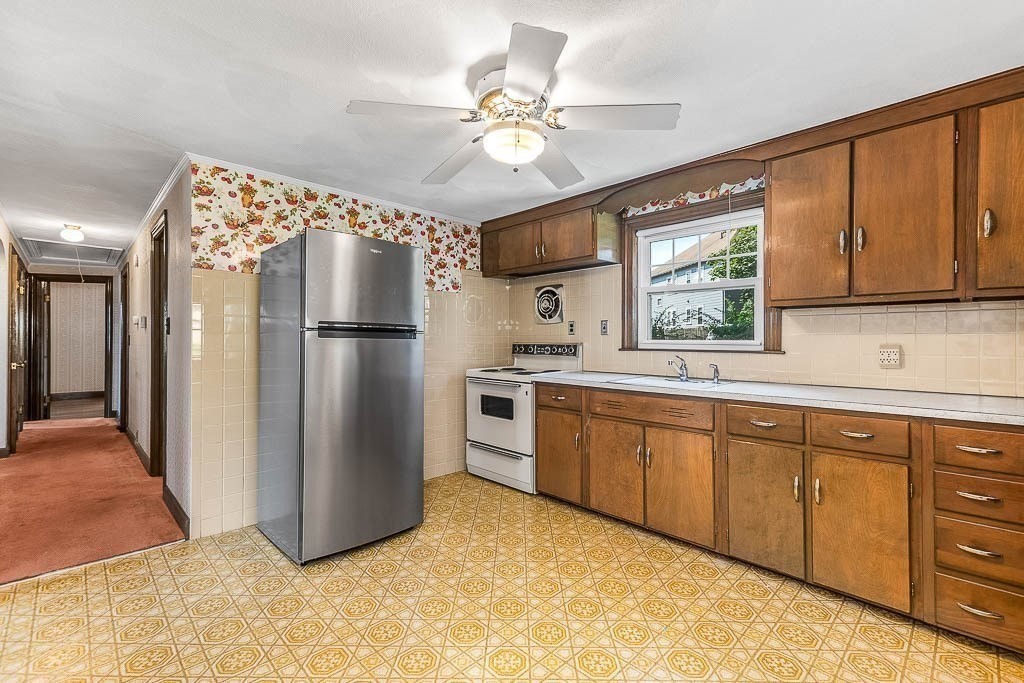 12 Juniper Terrace Dedham, MA 02026 - Photo 15 of 41 a kitchen with stainless steel appliances a refrigerator sink and cabinets