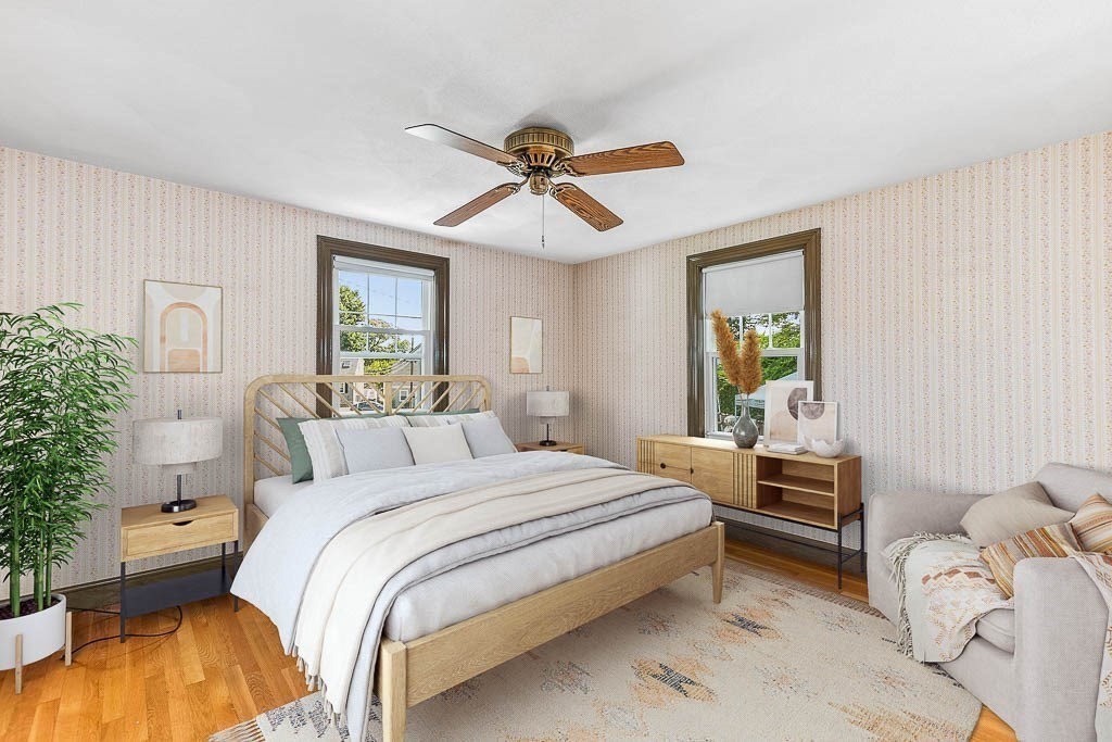 12 Juniper Terrace Dedham, MA 02026 - Photo 19 of 41 a bedroom with a bed and a chandelier