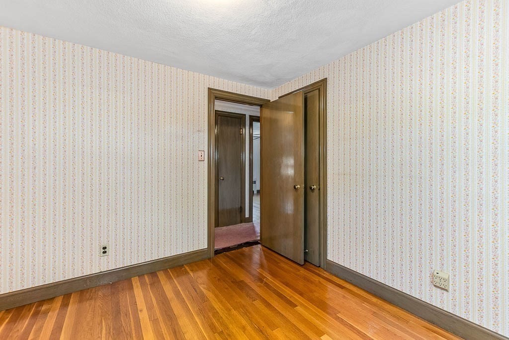 12 Juniper Terrace Dedham, MA 02026 - Photo 22 of 41 a view of an empty room with wooden floor