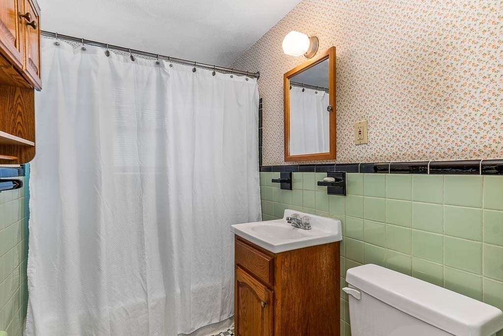 12 Juniper Terrace Dedham, MA 02026 - Photo 26 of 41 a bathroom with a sink a toilet and a mirror