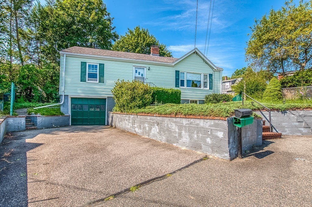 12 Juniper Terrace Dedham, MA 02026 - Photo 3 of 41 a front view of a house with a yard and a garage