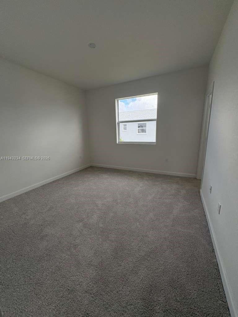 35663 Southwest 178th Court Homestead, FL 33034 - Photo 16 of 23 a view of an empty room with a window