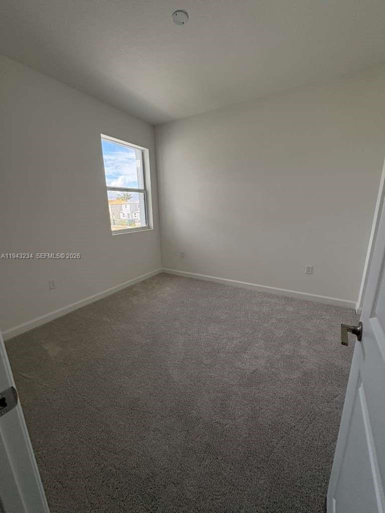 35663 Southwest 178th Court Homestead, FL 33034 - Photo 17 of 23 an empty room with a window