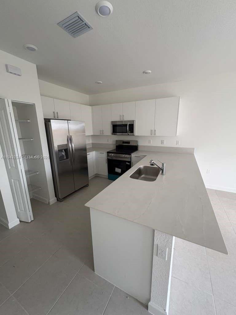 35663 Southwest 178th Court Homestead, FL 33034 - Photo 3 of 23 a kitchen with stainless steel appliances a refrigerator sink and microwave