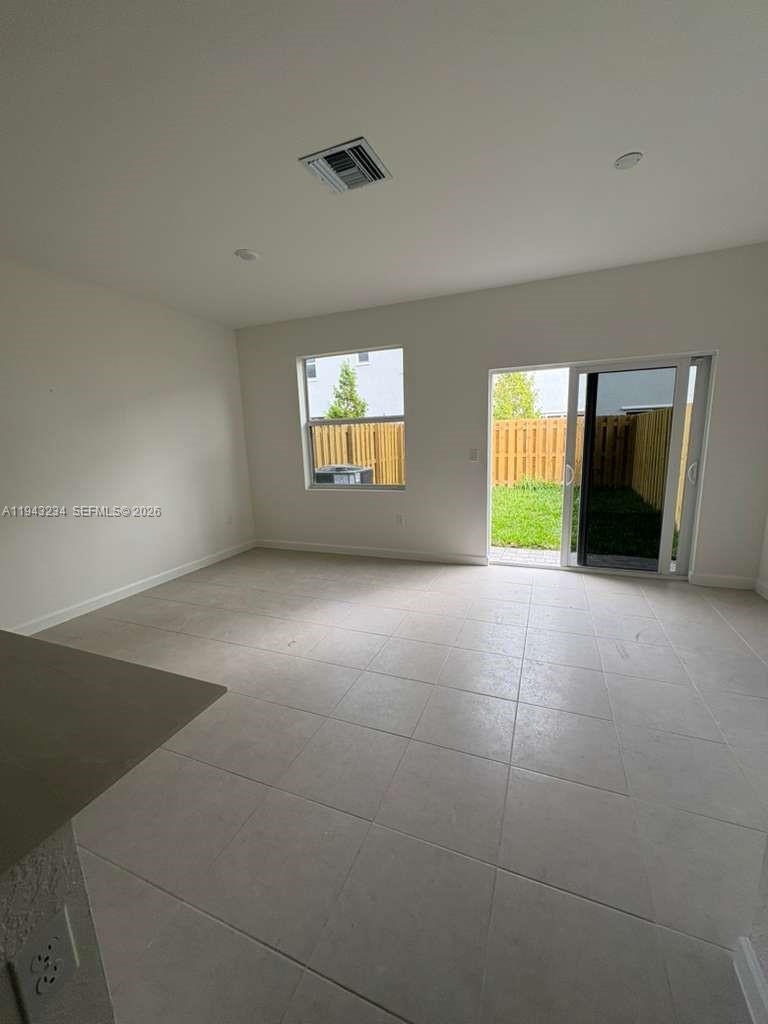 35663 Southwest 178th Court Homestead, FL 33034 - Photo 4 of 23 an empty room with windows and fireplace