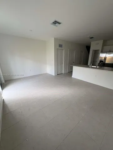 a view of a livingroom with furniture and a window