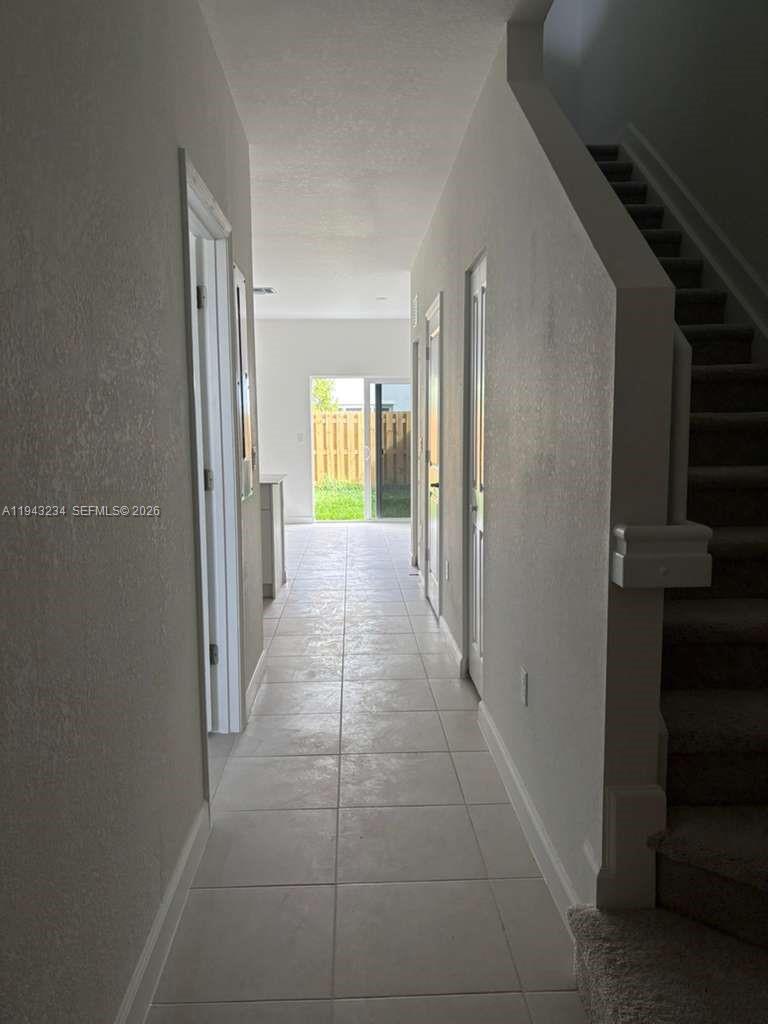 35663 Southwest 178th Court Homestead, FL 33034 - Photo 7 of 23 a view of a hallway with windows and a bathroom
