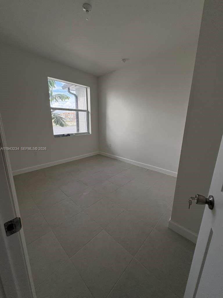 35663 Southwest 178th Court Homestead, FL 33034 - Photo 8 of 23 an empty room with windows