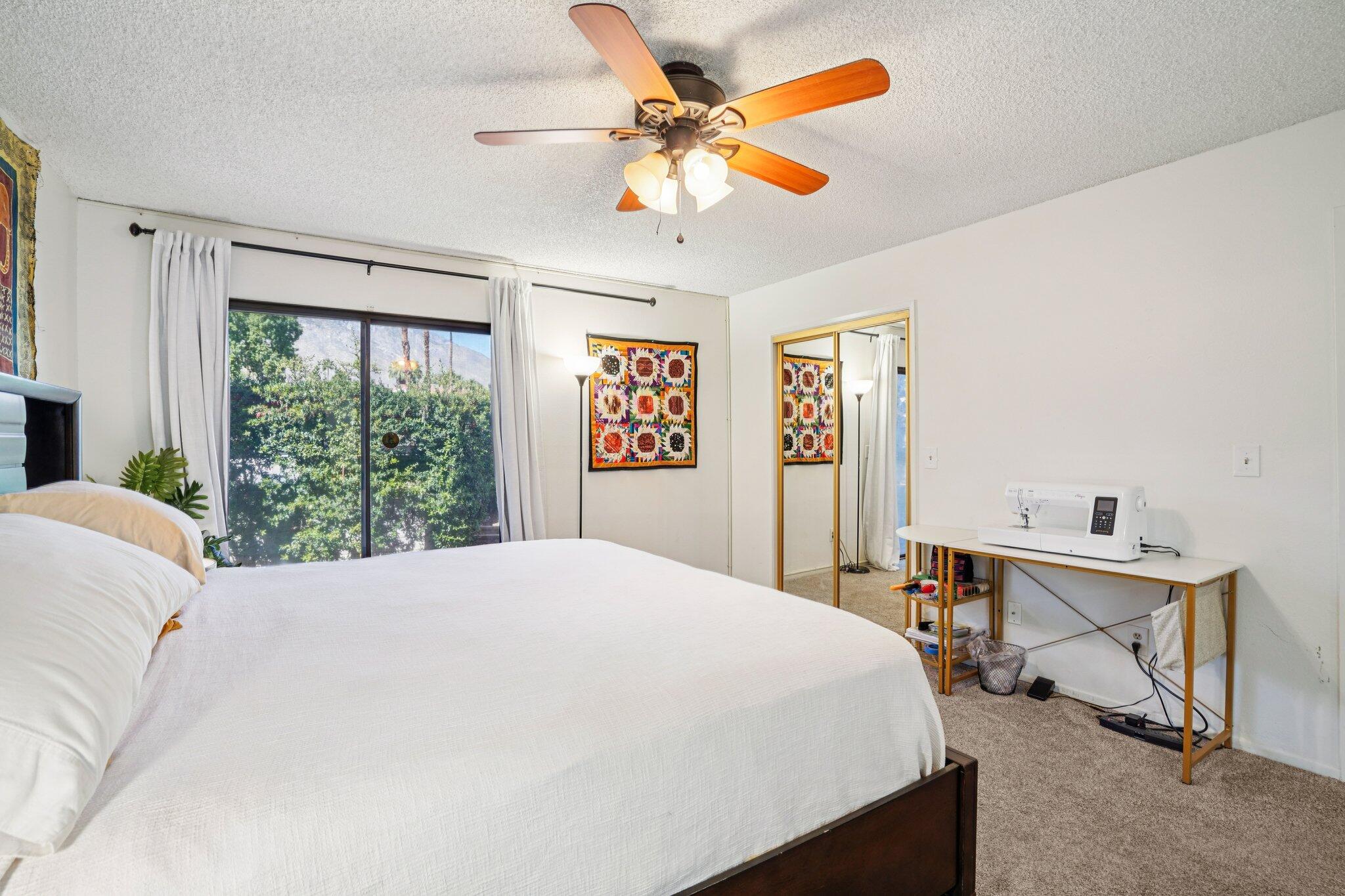 3155 Ramon Road, Unit 311 Palm Springs, CA 92264 - Photo 13 of 29 a bed sitting in a bedroom next to a window