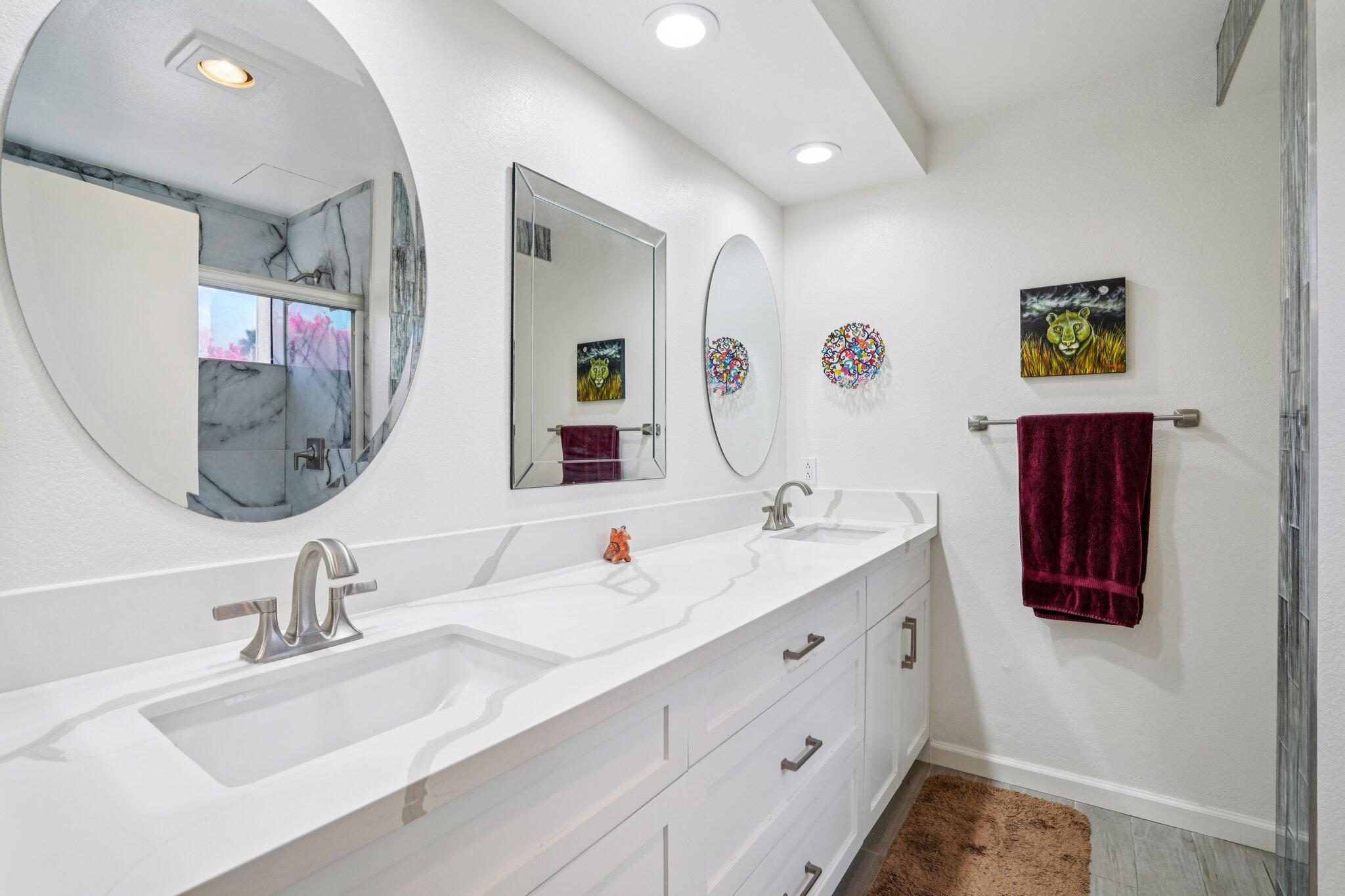 3155 Ramon Road, Unit 311 Palm Springs, CA 92264 - Photo 15 of 29 a bathroom with a double vanity sink and a mirror