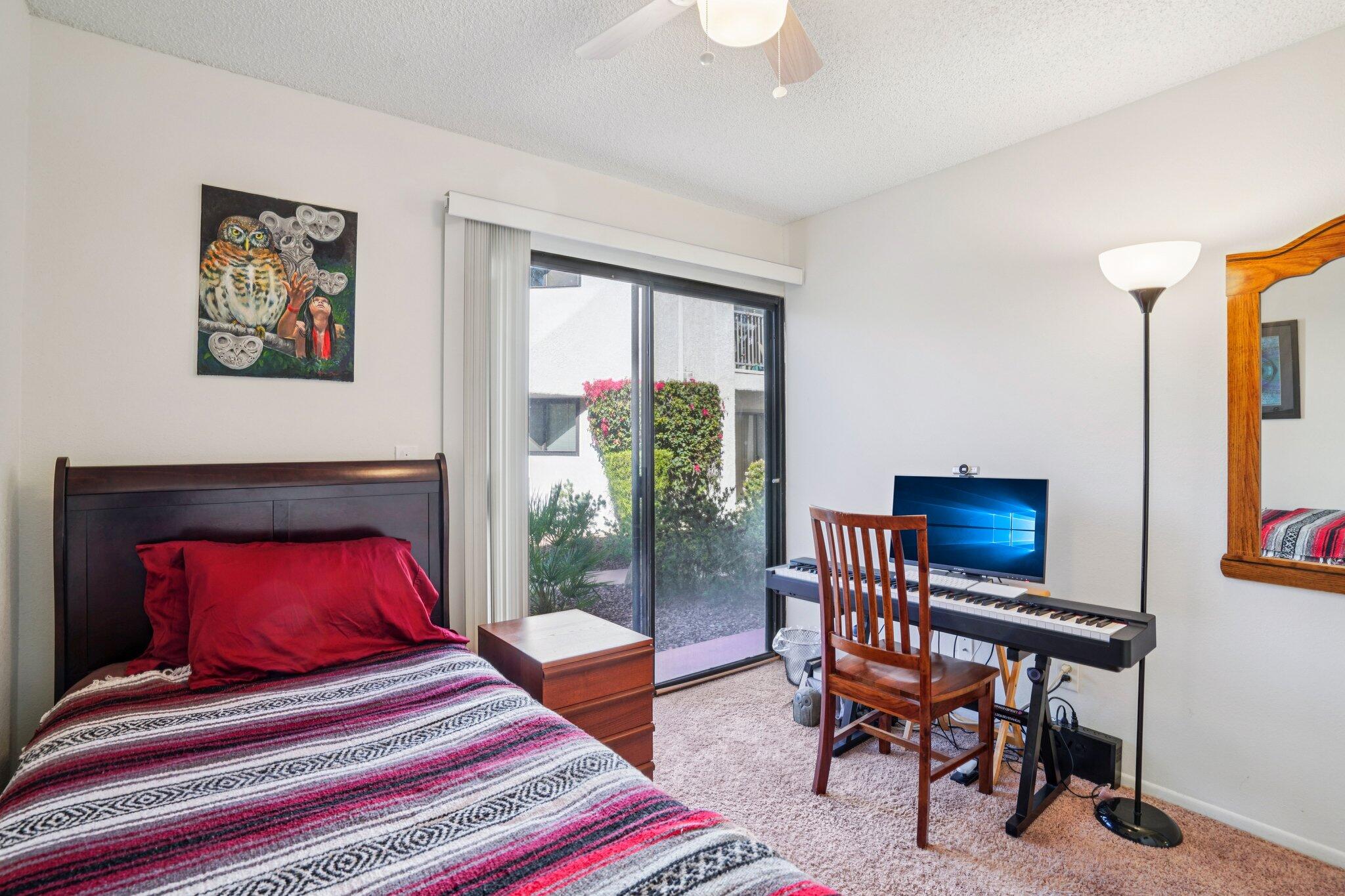 3155 Ramon Road, Unit 311 Palm Springs, CA 92264 - Photo 17 of 29 a bedroom with a bed a table and a potted plant