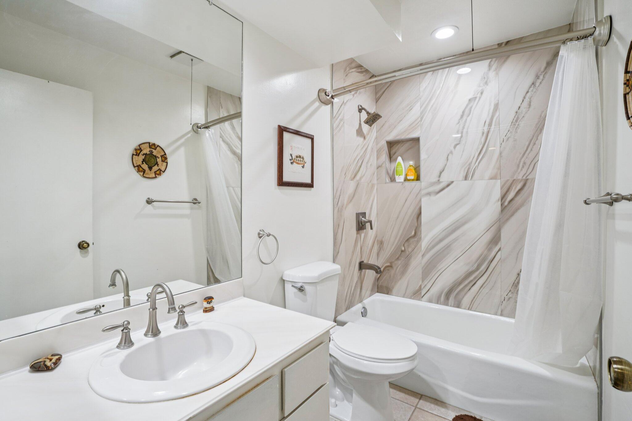 3155 Ramon Road, Unit 311 Palm Springs, CA 92264 - Photo 19 of 29 a bathroom with a sink toilet and shower