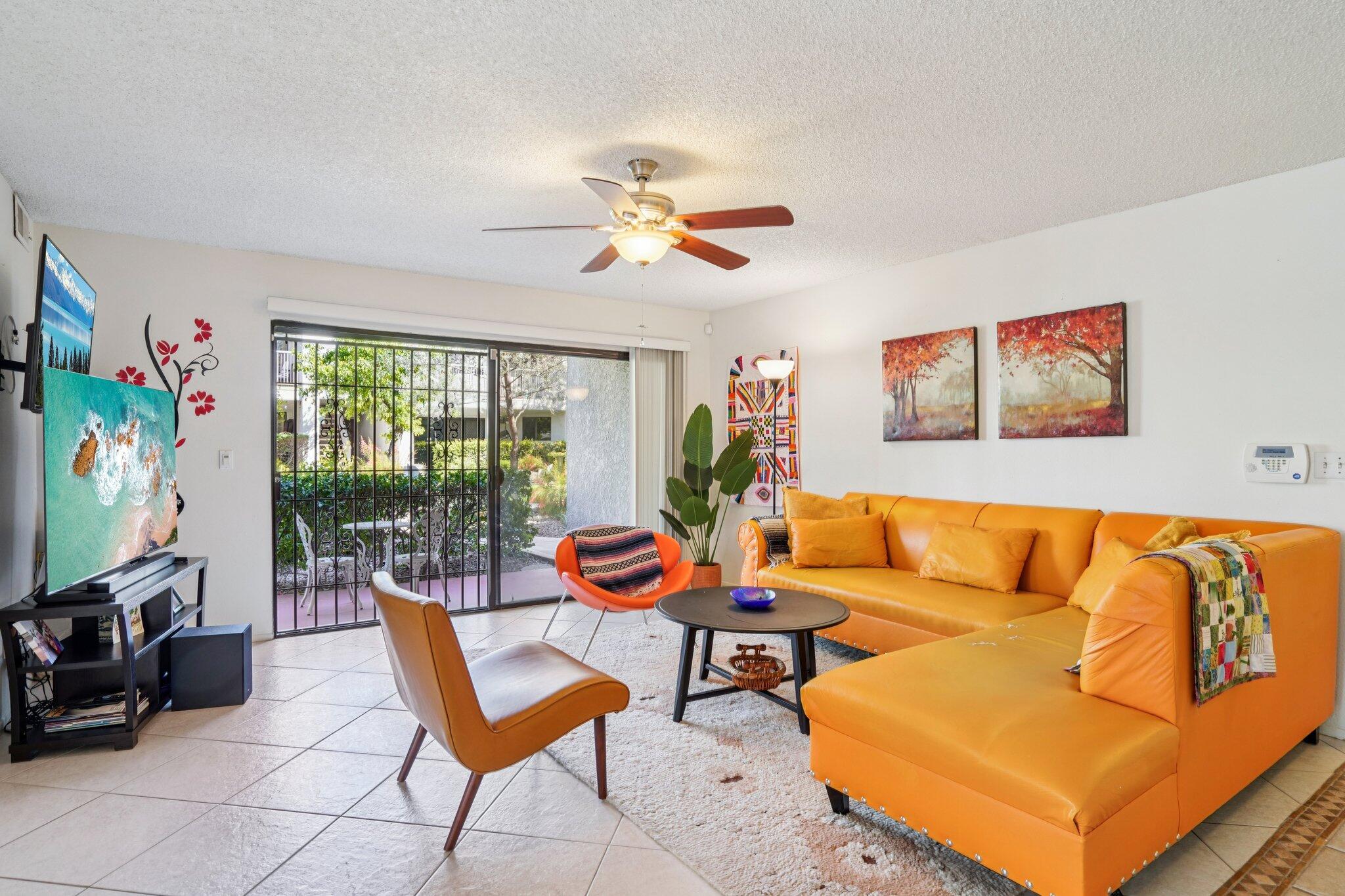 3155 Ramon Road, Unit 311 Palm Springs, CA 92264 - Photo 2 of 29 a living room with furniture a flat screen tv and a large window