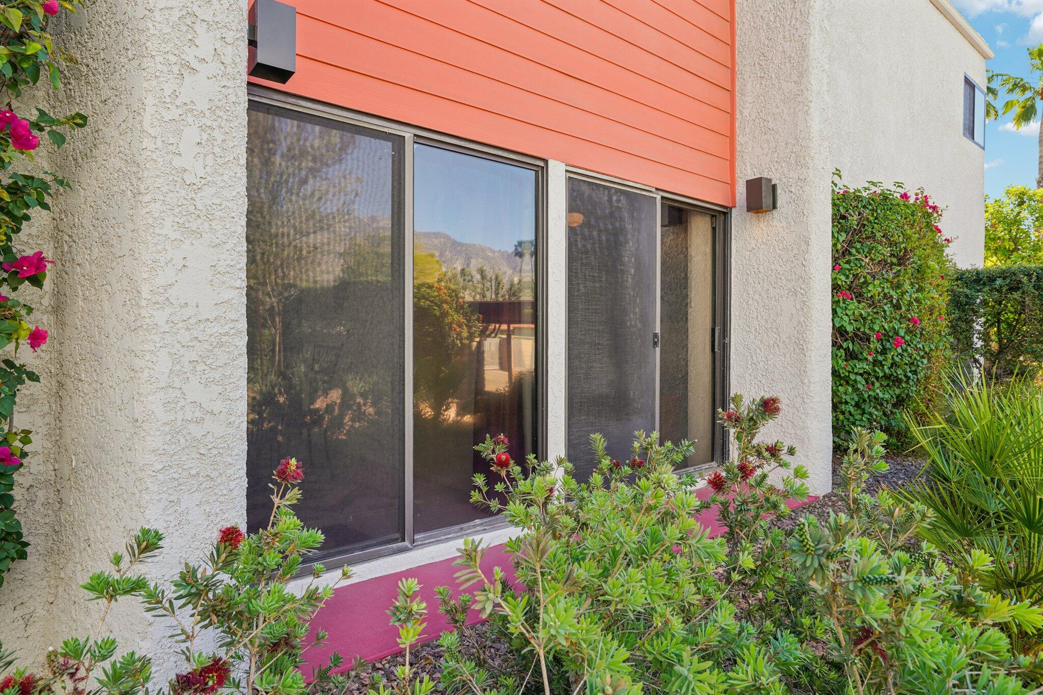 3155 Ramon Road, Unit 311 Palm Springs, CA 92264 - Photo 25 of 29 a flower garden with potted plants