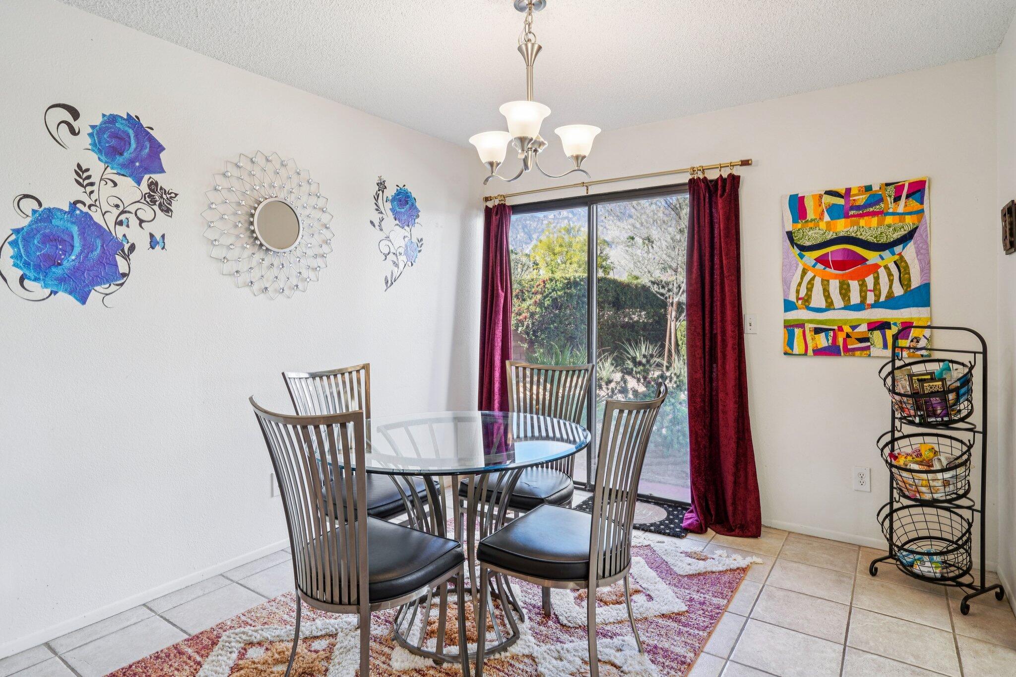 3155 Ramon Road, Unit 311 Palm Springs, CA 92264 - Photo 4 of 29 a view of a dining room with furniture wooden floor and a chandelier