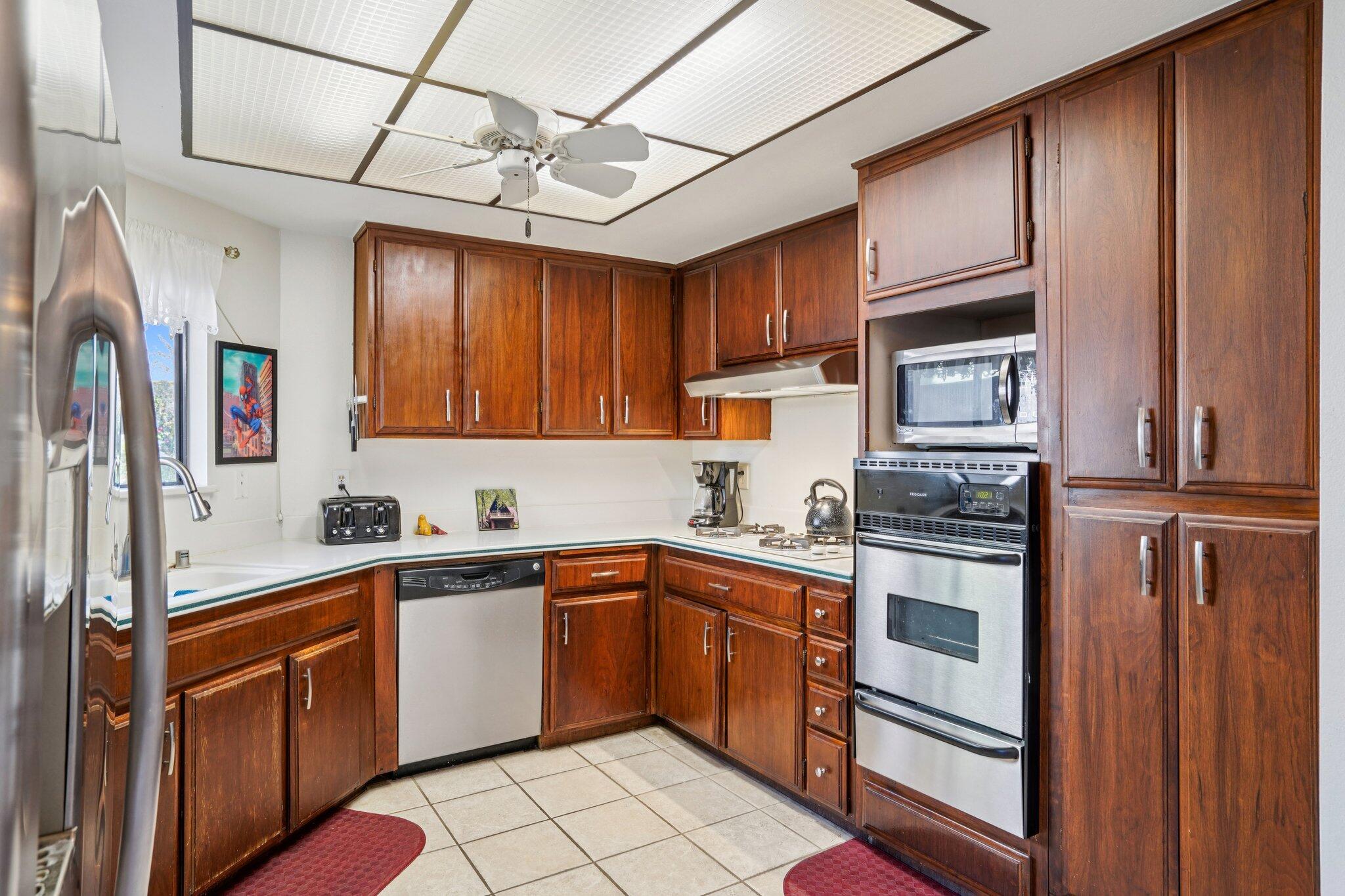 3155 Ramon Road, Unit 311 Palm Springs, CA 92264 - Photo 7 of 29 a kitchen with stainless steel appliances granite countertop a sink stove and refrigerator