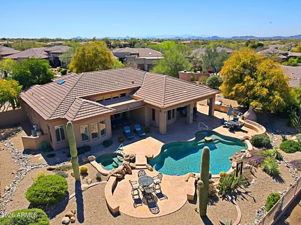 an aerial view of a house with garden space and lake view