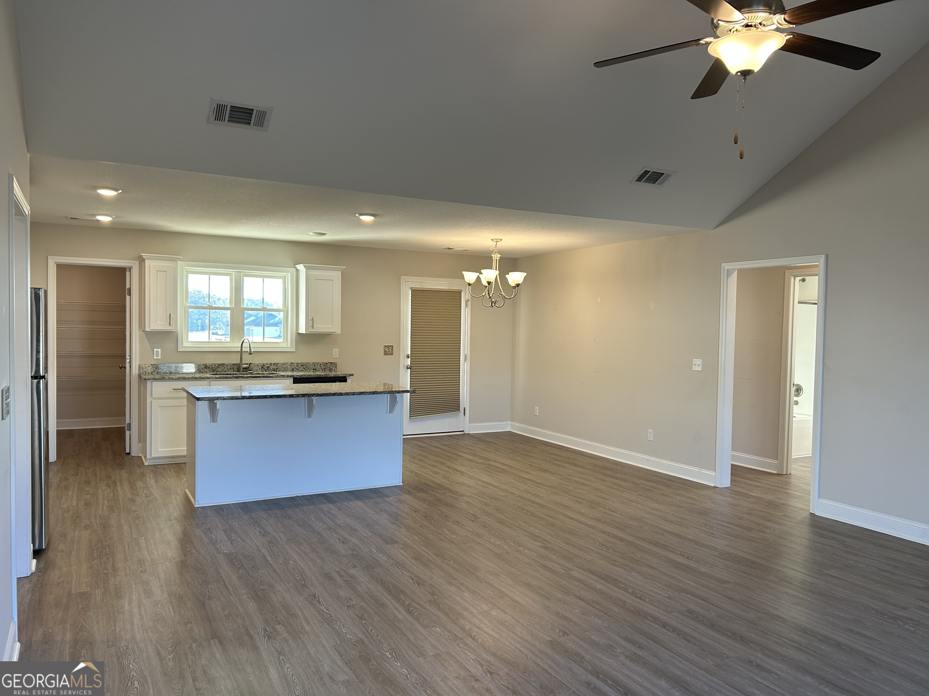 106 Old Barn Road Statesboro, GA 30458 - Photo 15 of 59 a large kitchen with stainless steel appliances granite countertop a large counter top a sink and a chandelier