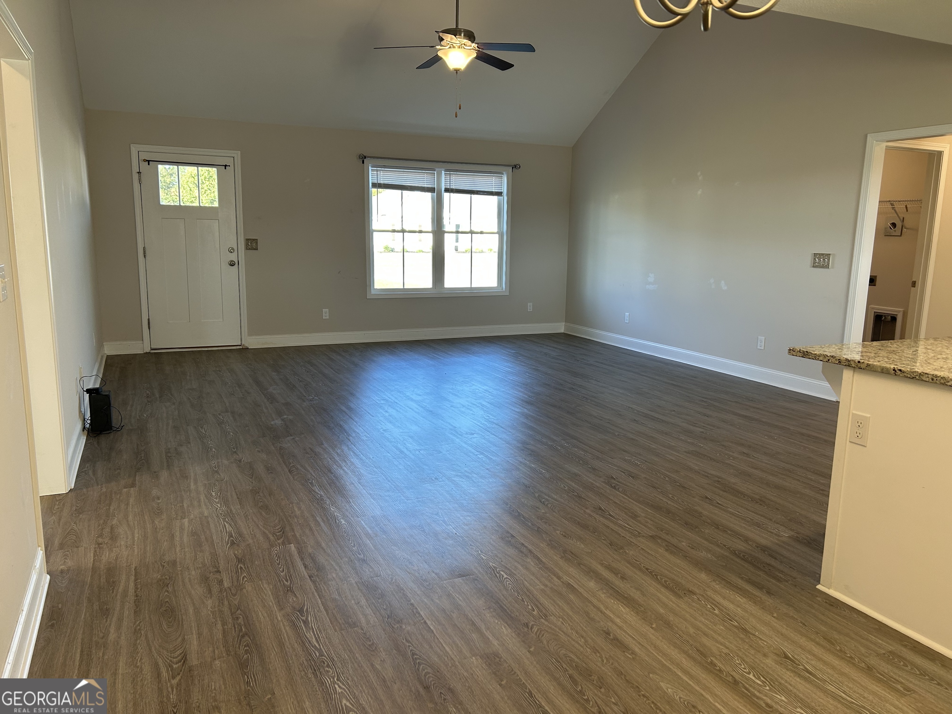 106 Old Barn Road Statesboro, GA 30458 - Photo 16 of 59 an empty room with wooden floor and windows