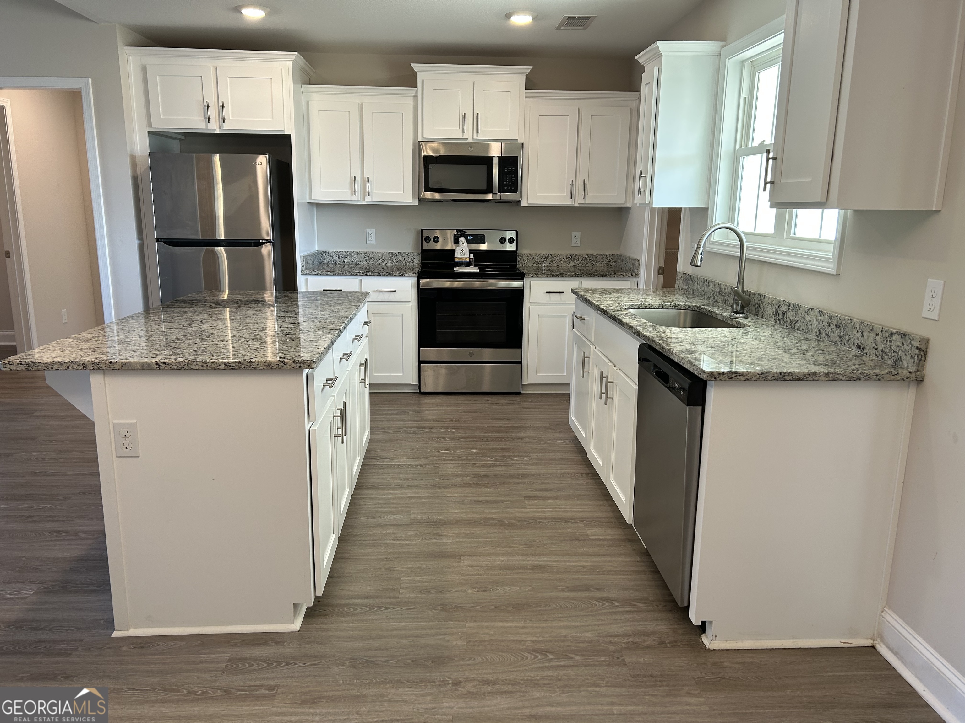106 Old Barn Road Statesboro, GA 30458 - Photo 17 of 59 a kitchen with stainless steel appliances granite countertop a stove top oven a refrigerator and white cabinets