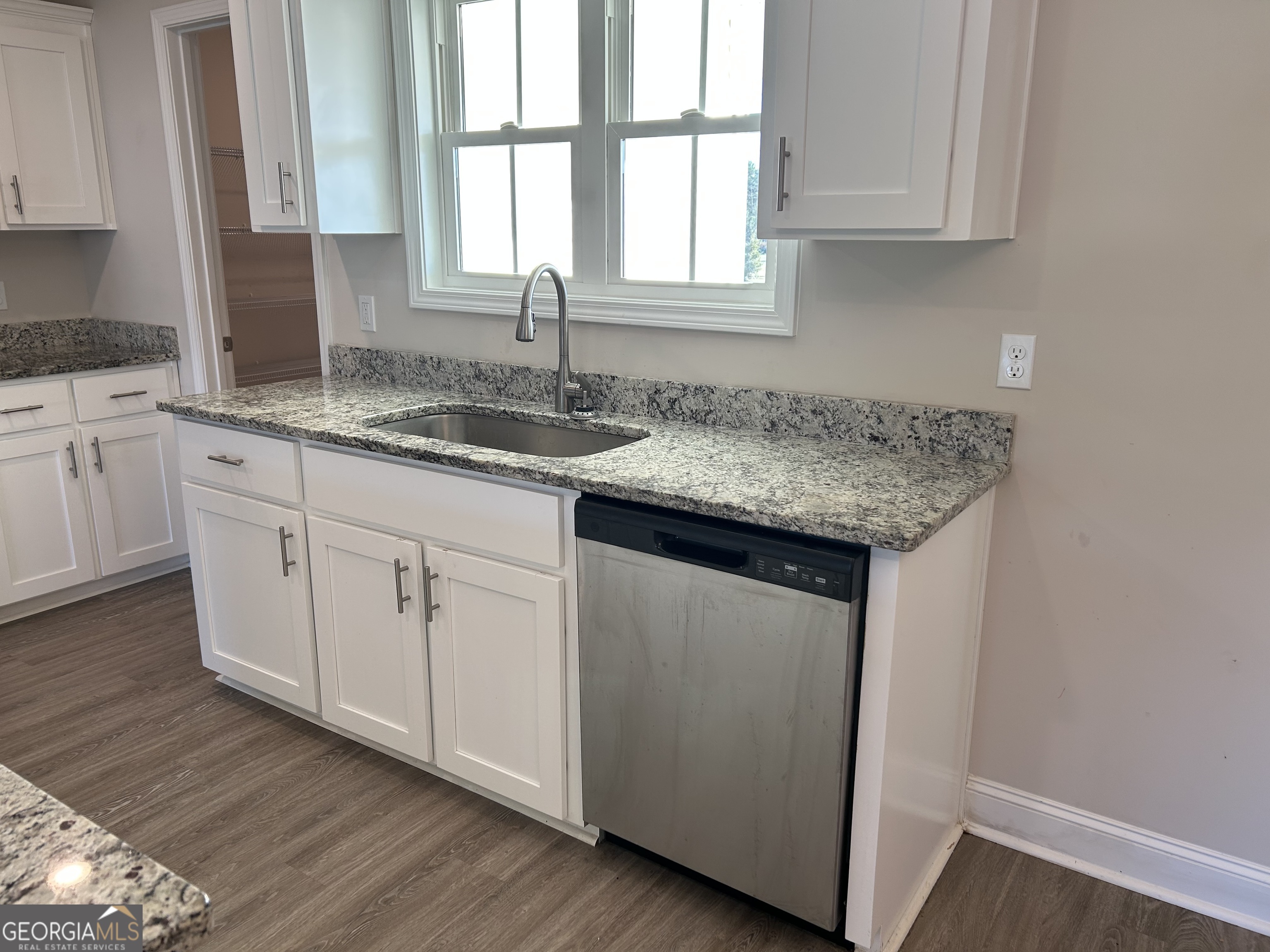 106 Old Barn Road Statesboro, GA 30458 - Photo 18 of 59 a kitchen with granite countertop white cabinets and a sink