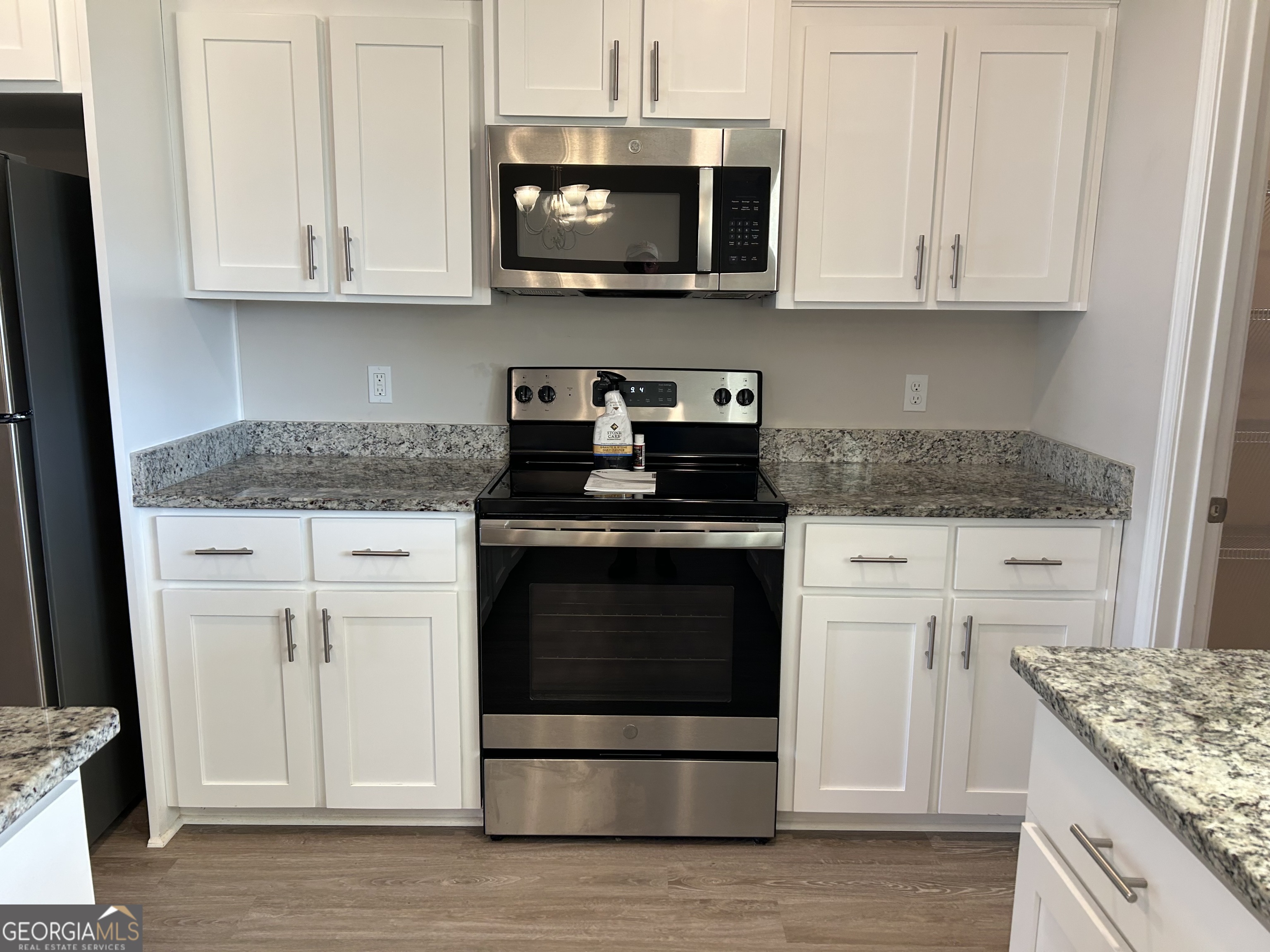 106 Old Barn Road Statesboro, GA 30458 - Photo 19 of 59 a kitchen with stainless steel appliances granite countertop a stove a microwave and oven