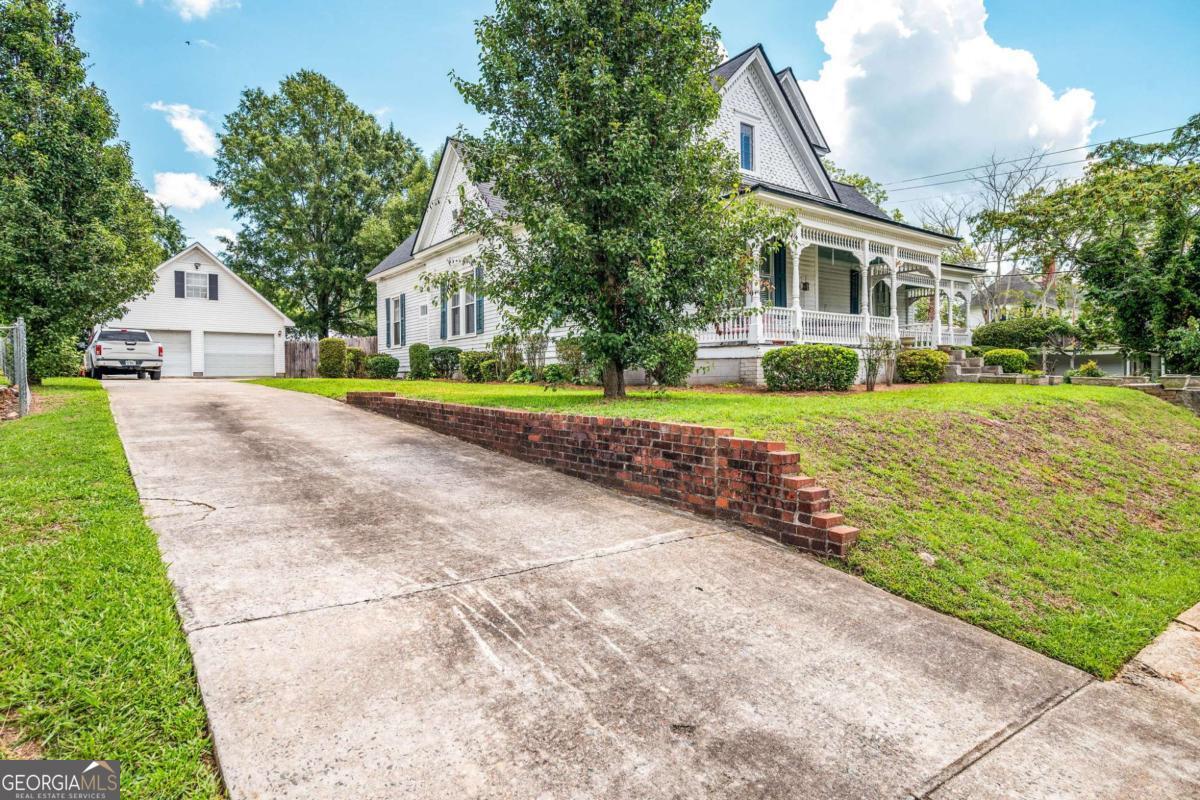 300 North Maple Street Eatonton, GA 31024 - Photo 1 of 1 a front view of a house with a yard and garage