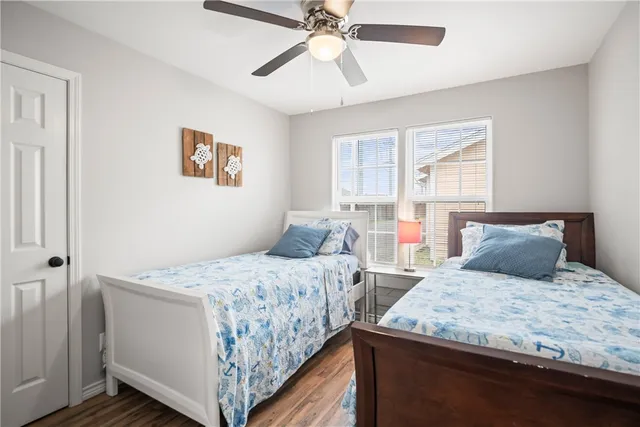 a bedroom with two beds and a chandelier