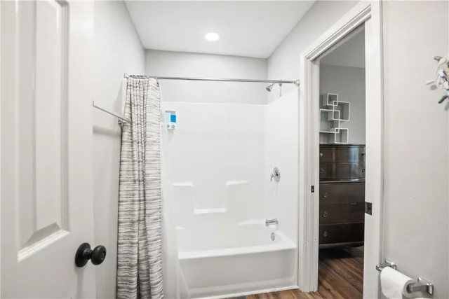 a bathroom with a bathtub and a shower