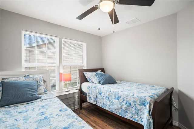 a bedroom with a large bed and a window