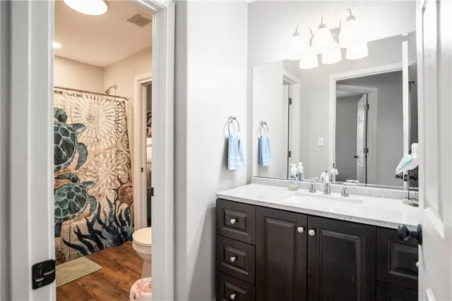 a bathroom with a double vanity sink mirror and shower