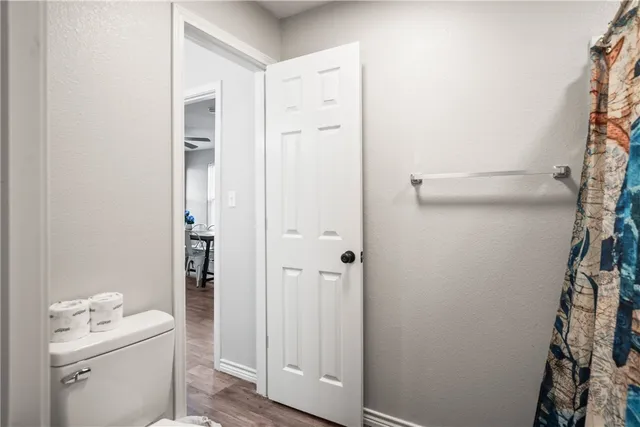a bathroom with a toilet a sink and shower