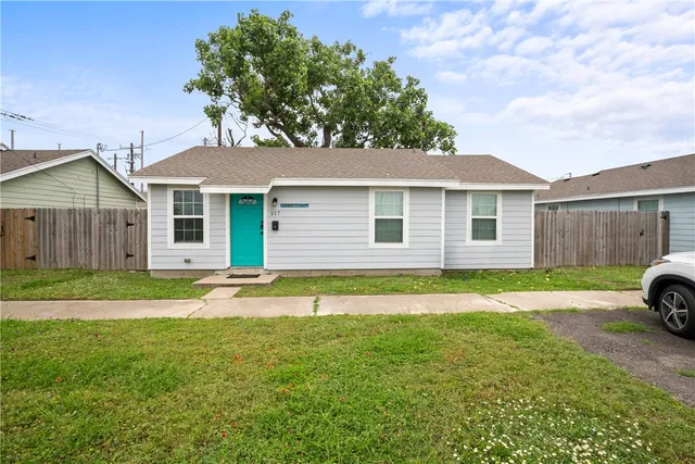 a view of a house with a yard and tree s